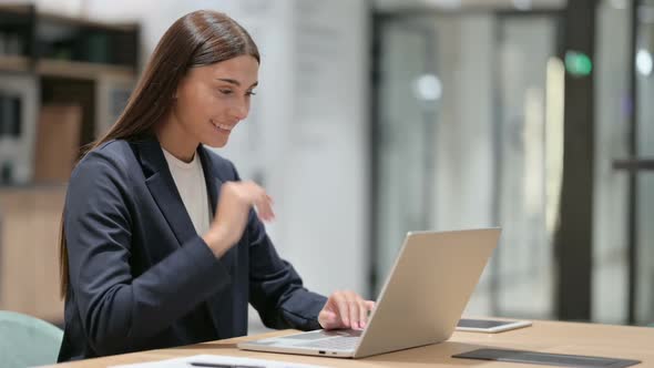 Businesswoman Doing Video Chat on Laptop alt