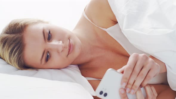 Young woman lying in the bed. Beautiful blond sleeping girl. Morning in the bedroom. alt