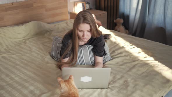 Serious Young Woman Freelancer Working on Freelance From Home Typing on Laptop