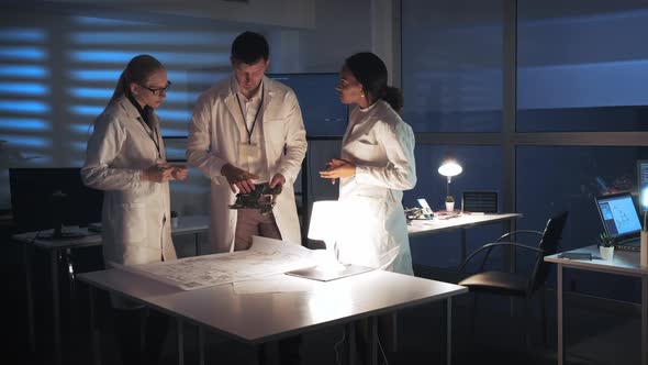 Technology Research Facility: Multiracial Electronics Development Engineers in White Coats Working alt