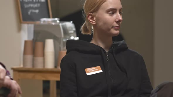 Stressed Young Woman at Group Therapy Session alt