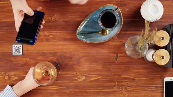 Scanning QR Code in Restaurant Top View alt