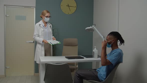 Female Doctor and Man Wearing Mask for Protection Against Coronavirus alt