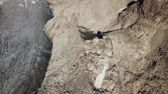 Tilt up, drone view of rocky mountains in the alps, Switzerland and glacier alt