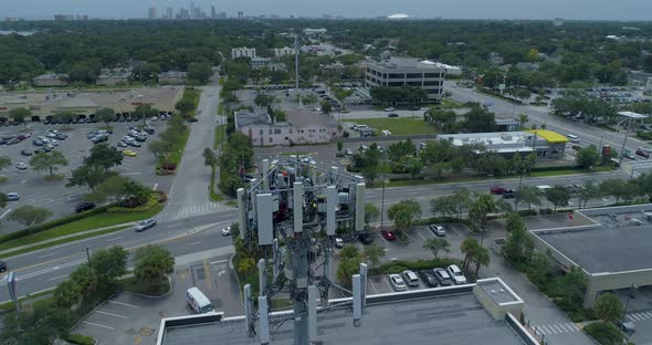 4K Aerial video of cellular tower technicians servicing antennas alt