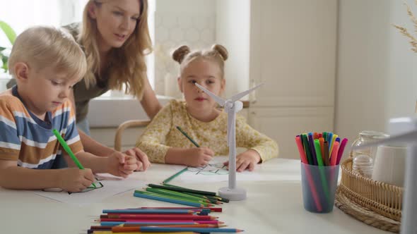 Video of children coloring a recycle symbol. Shot with RED helium camera in 8K alt