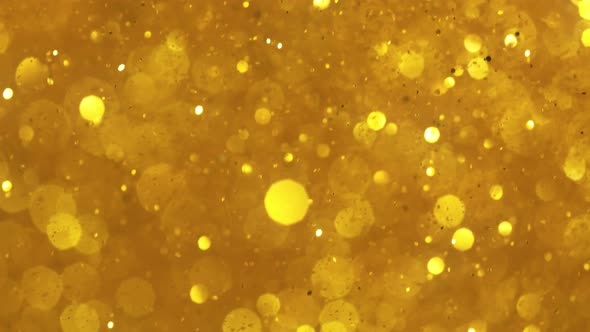 Super Slow Motion Shot of Golden Glitter Background at 1000Fps alt