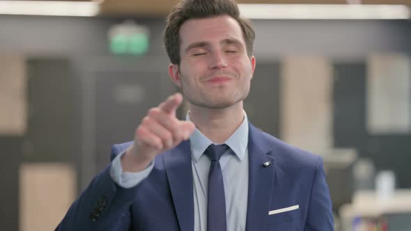 Portrait of Businessman Pointing at the Camera alt