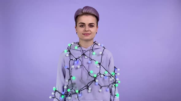 Positive Lgbt Person Hung with Lights Sharing Exhilaration Indoors alt