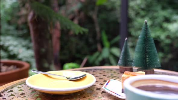 A woman drinking coffee in outdoors cafe