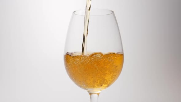 Whiskey pour into a glass on a white background