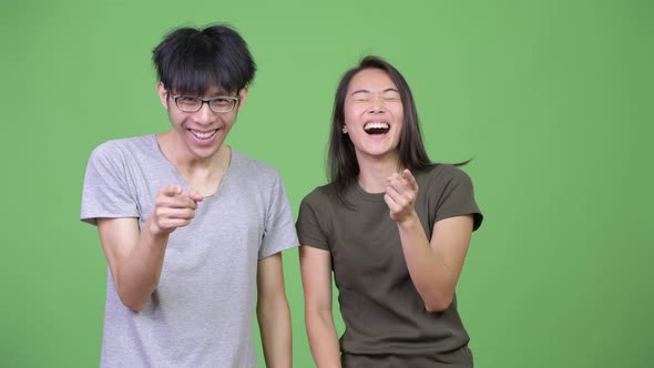 Young Asian Couple Laughing Together
