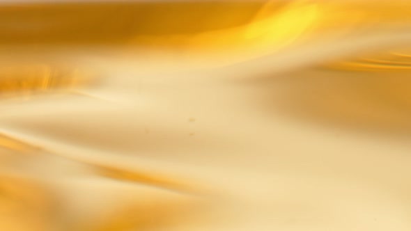 Super Slow Motion Abstract Shot of Waving Golden Oil Background at 1000Fps alt