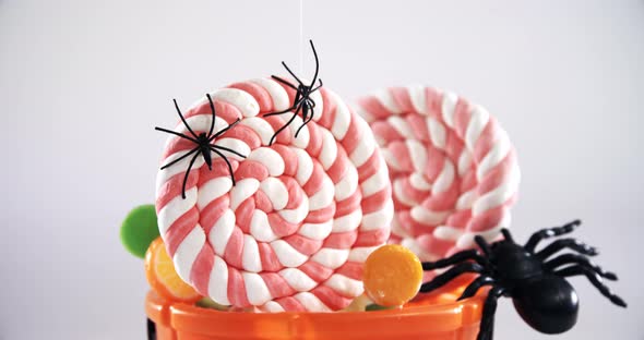 Halloween bucket filled up with lollipop 4k alt