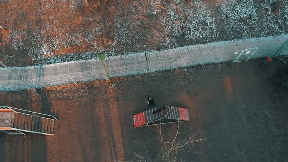 A Field for the Dog Training - a Trainer and His Dog Running - the Dog Running Through Obstacles alt