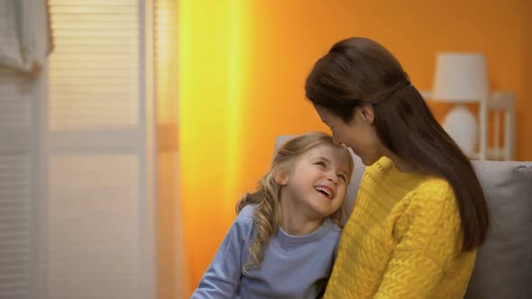 Cheerful Mother and Little Daughter Smiling and Looking to Camera alt