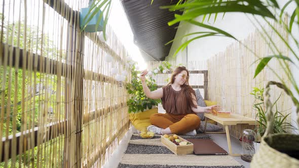 Attractive Woman Blogger Shoots Video on Decorated Terrace
