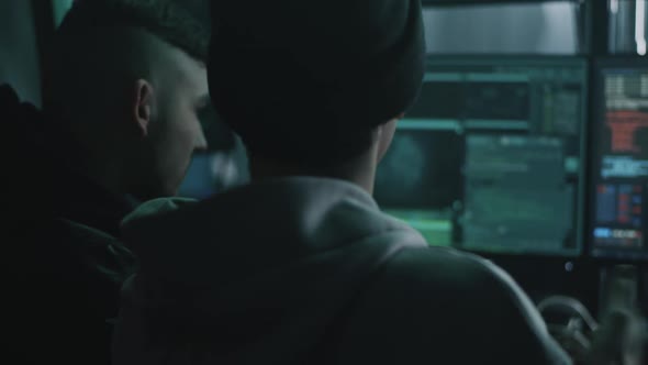 Male Hackers Copying Hacked Data alt