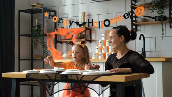 Woman with Daughter Playing Halloween Memory Game alt