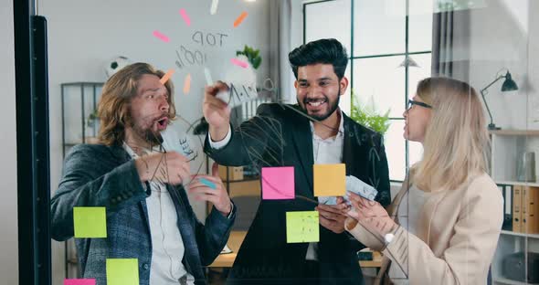 Creative Male and Female Team Scattering Money in Office After Successful Ending Start Up Project alt