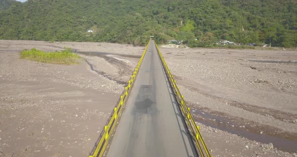 Aerial drone video, old bridge along the road that leads to Villavicencio / Colombia, passing the ri alt