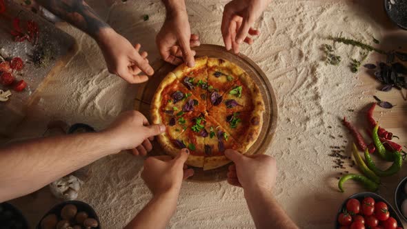 Friends Group Sharing Pizza Slice on Cutting Board Table at Restaurant Pizzeria alt