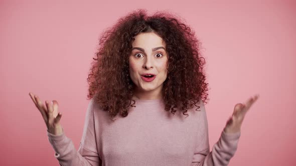 Portrait of Girl with Curly Hair, She Shows Wow Delight Effect gesture.Surprised alt