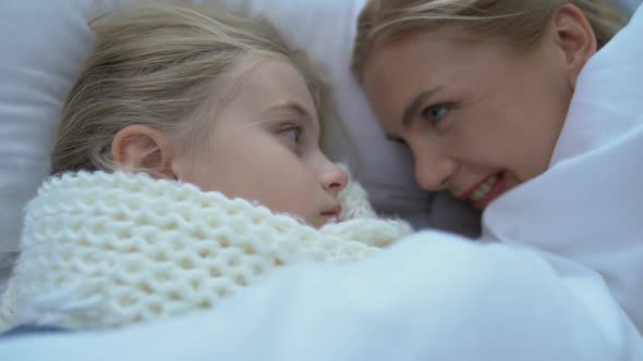 Mother Lying Near Little Ill Daughter in Scarf, Supporting Child, Grippe or Flu