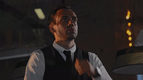 A Businessman Approaches the Panoramic Glass in the Office Meditates Thinks alt