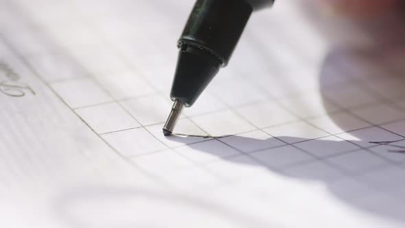 Caucasian Male's Hand with a Black Pen is Writing Digit One on a Paper
