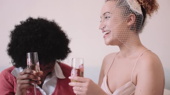 Mother and daughter toasting in bridal studio