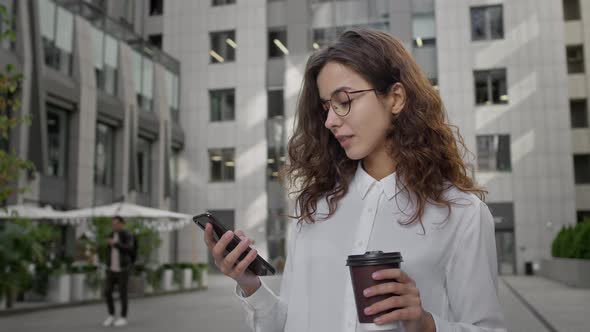 Young Girl Takes Break While Working With Coffee On The Street alt