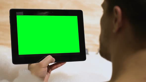 Male Holding Prekeyed Tablet, Lying in Bathtub, Template for Advertisement, App alt