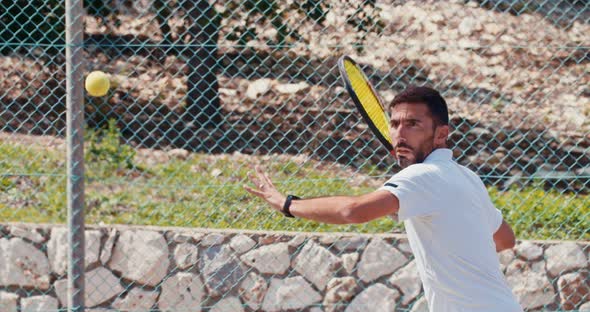 Slow motion of a tennis player hitting the ball during a tennis game alt