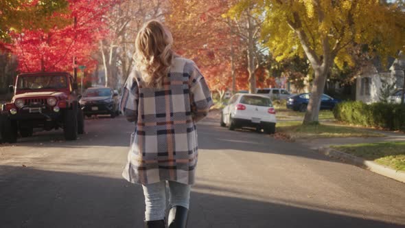 Slow Motion Golden Autumn Young Woman Walking By Street in Small Suburban Town alt