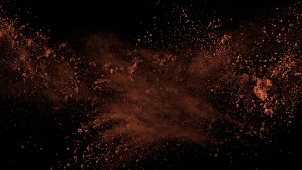 Super Slow Motion Shot of Cocoa Powder Explosion Isolated on Black Background at 1000Fps. alt