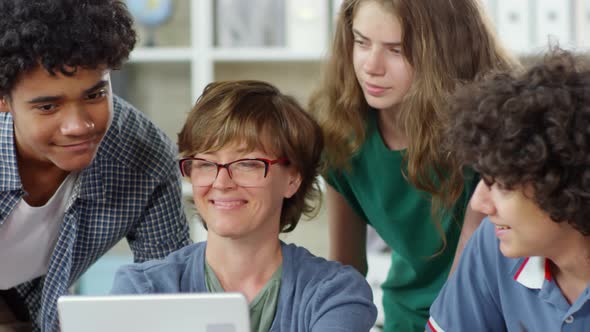 Pupils and Teacher Using Laptop alt