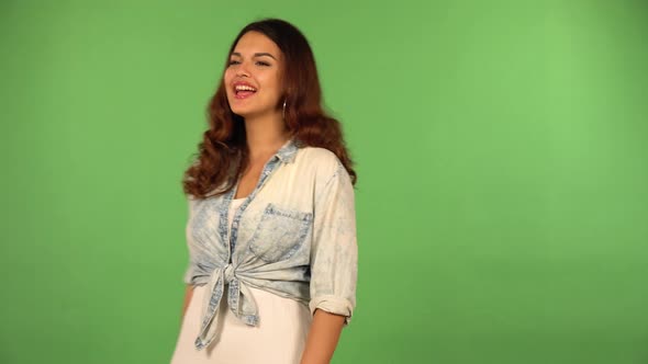 A Young Beautiful Caucasian Woman Celebrates with a Smile  Green Screen Background