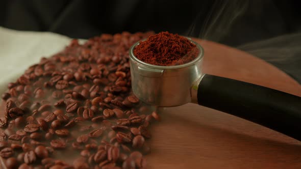 Ground Coffee in Portafilter on Wooden Board with Coffee Beans and Dissipating Steam alt