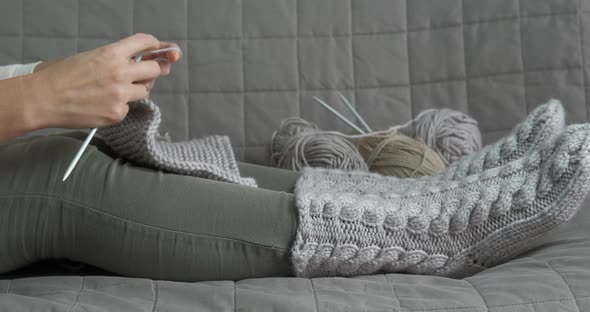 Hand knits a scarf. alt