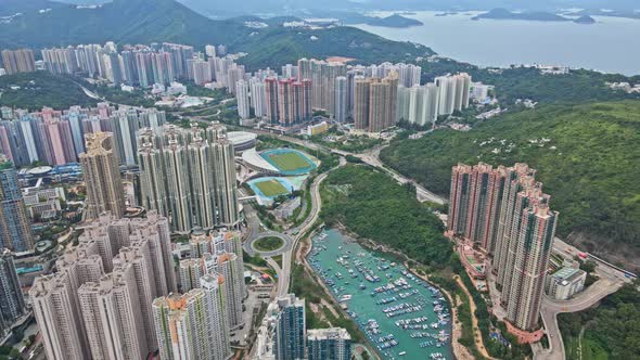 A dynamic aerial footage of the cityscape of Tseung Kwan O New town surrounded by various skyscraper alt