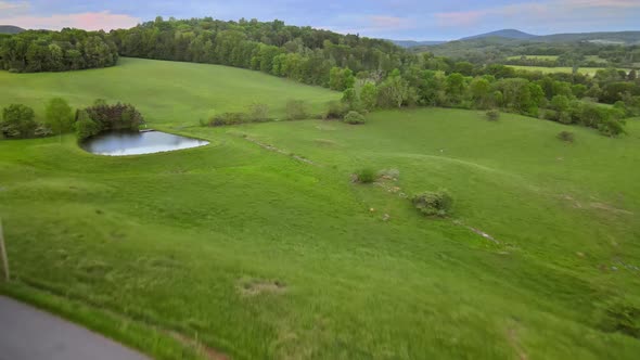 Mountain Pocono Pennsylvania landscape with a pond between green forest and blue sky alt