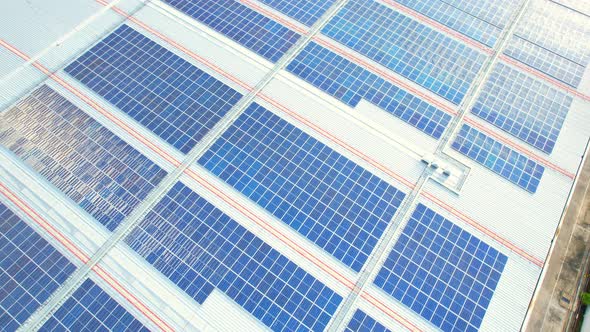Aerial cinematic view of a solar panel on mall roof top alt