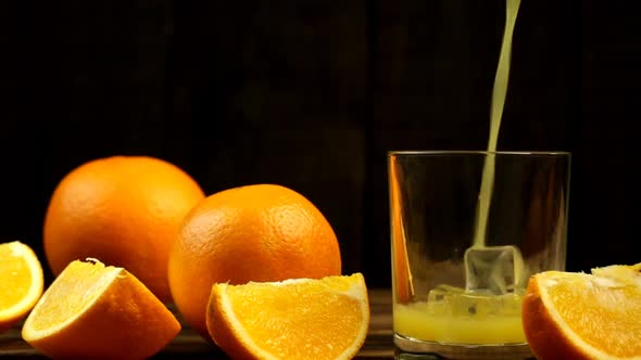 Pour Juice, Several Whole Oranges And Chopped Oranges Into A Glass With Ice