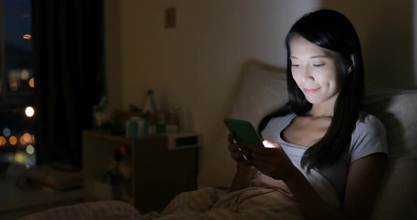 Woman use of tablet computer on bed alt
