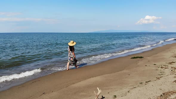 Woman Walking Alone at Long Beach alt