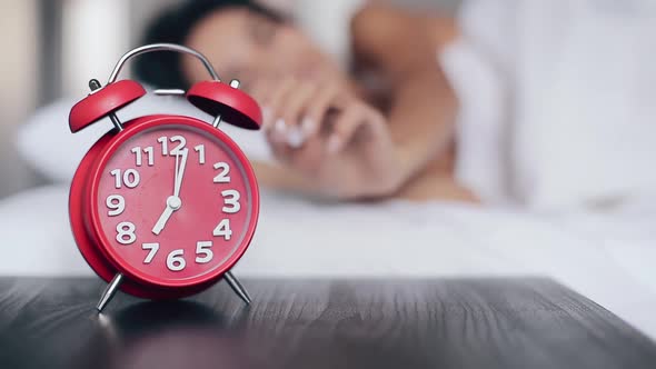 Beautiful Girl Sleeps in Bed Turns Off Alarm Clock and Keeps Sleeping alt