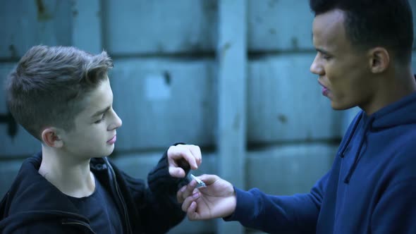 Teenager Boy Smoking Weed in Backstreet, Influence of Older Troubled Friend alt