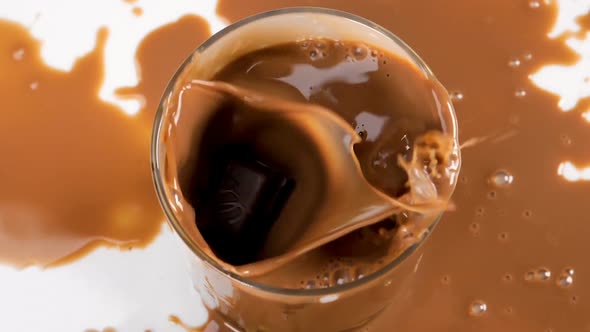 Chocolate Pieces Falling in Milk
