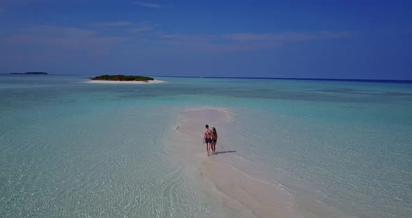 Young man and woman married on vacation enjoy luxury on beach on sunny white sandy background alt
